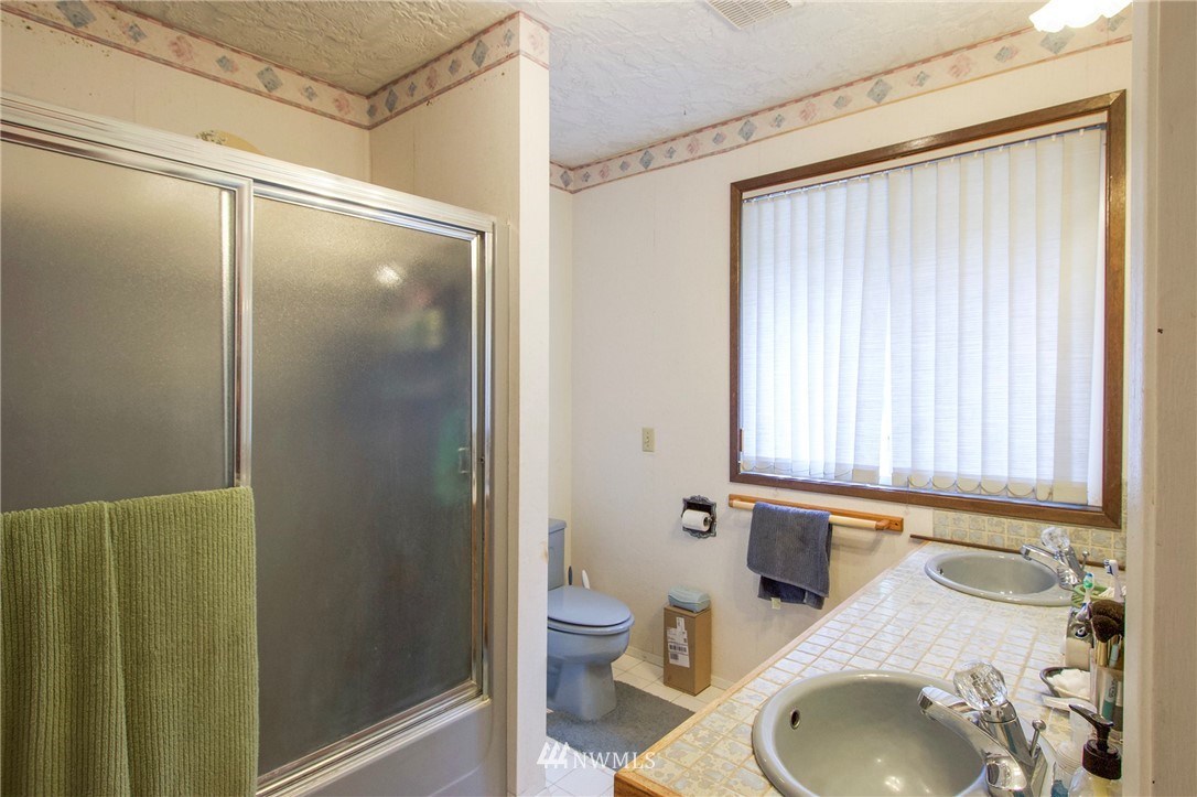 1493 Atterberry Road Sequim, WA 98382 - Photo 22 of 40 a bathroom with a sink and a mirror