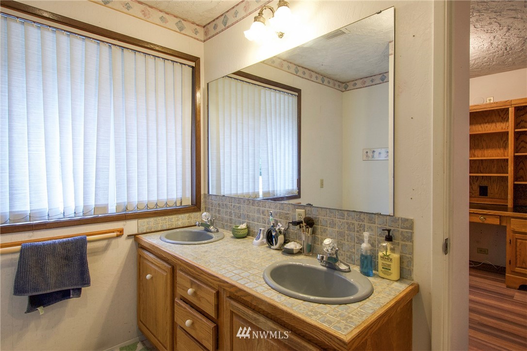 1493 Atterberry Road Sequim, WA 98382 - Photo 23 of 40 a bathroom with a sink and a mirror