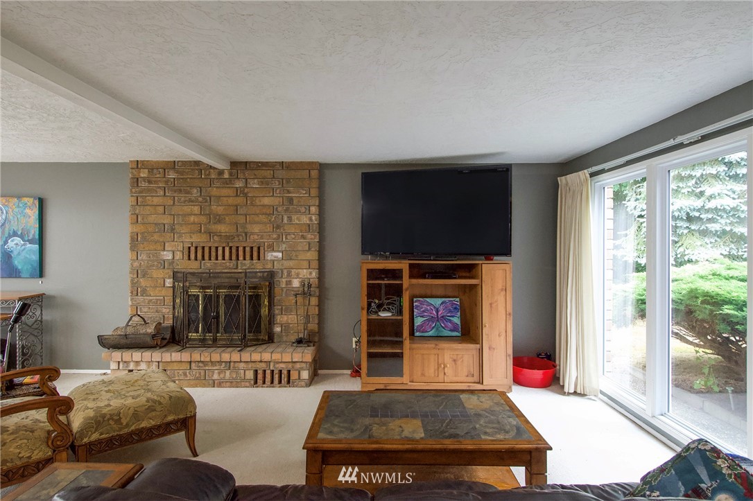 1493 Atterberry Road Sequim, WA 98382 - Photo 4 of 40 a living room with furniture a flat screen tv and a fireplace