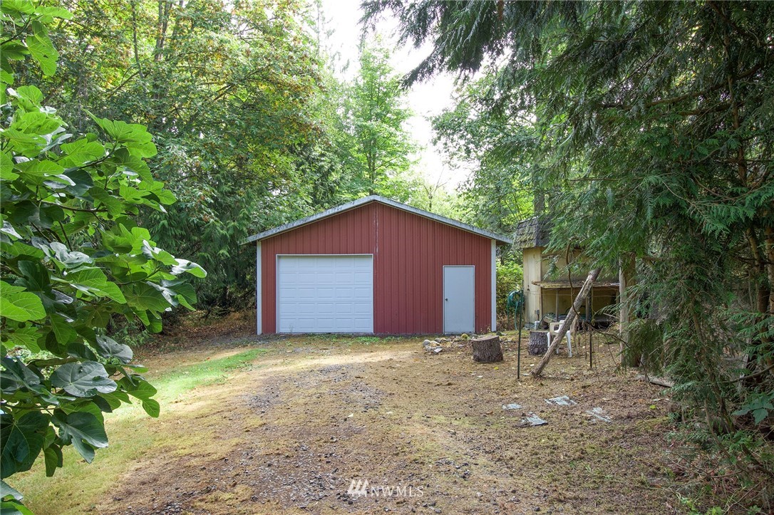 1493 Atterberry Road Sequim, WA 98382 - Photo 36 of 40 a large tree in front of a house