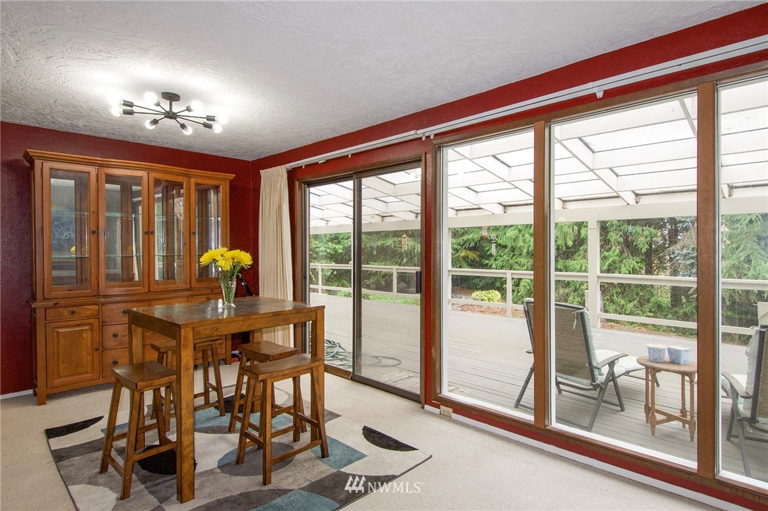 1493 Atterberry Road Sequim, WA 98382 - Photo 7 of 40 a view of a dining room with furniture large windows and wooden floor