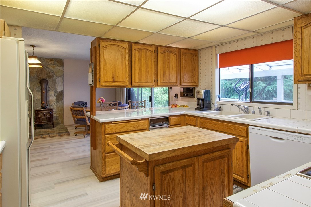 1493 Atterberry Road Sequim, WA 98382 - Photo 10 of 40 a kitchen with a sink a counter top space and cabinets