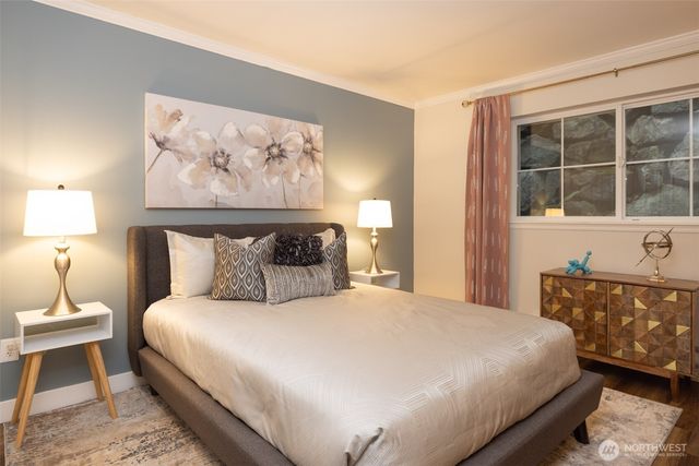 a bedroom with a large bed and a window