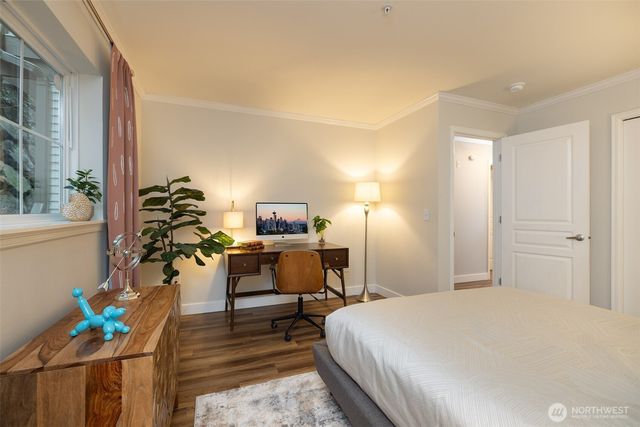 a bedroom with a bed and a potted plant