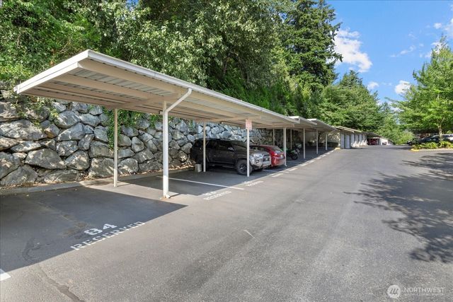 a view of a patio with table and chairs under an umbrella