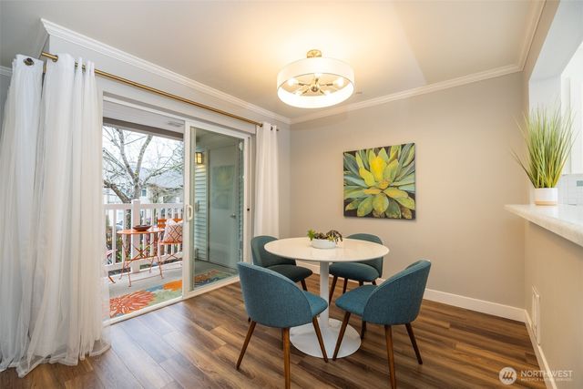 a view of a dining room with furniture a chandelier and wooden floor