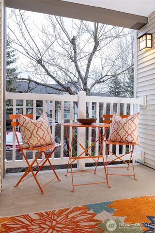 a view of a house with wooden deck and furniture