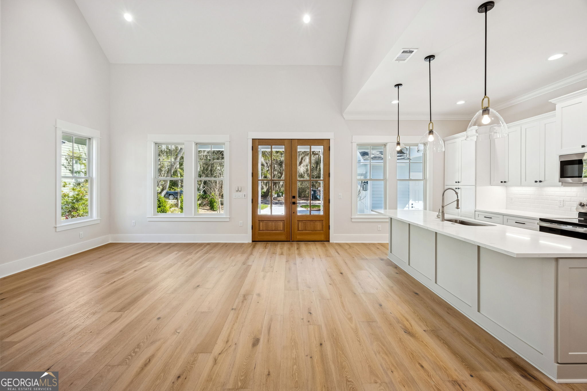 308 Anchor Way St. Marys, GA 31558 - Photo 18 of 55 a large kitchen with lot of center island wooden floor stainless steel appliances and window