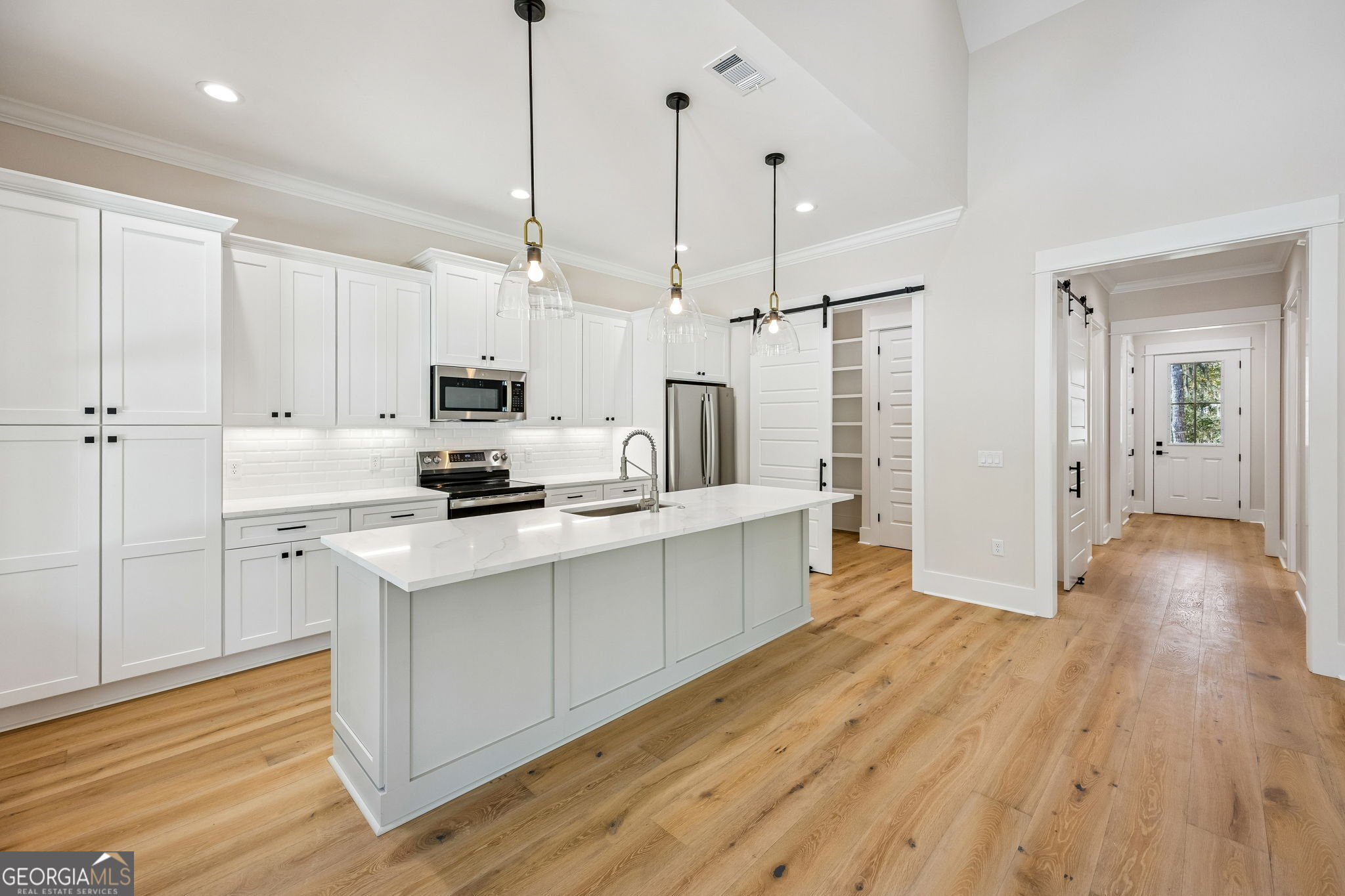 308 Anchor Way St. Marys, GA 31558 - Photo 24 of 55 a kitchen with stainless steel appliances a stove top oven a sink a refrigerator and cabinets