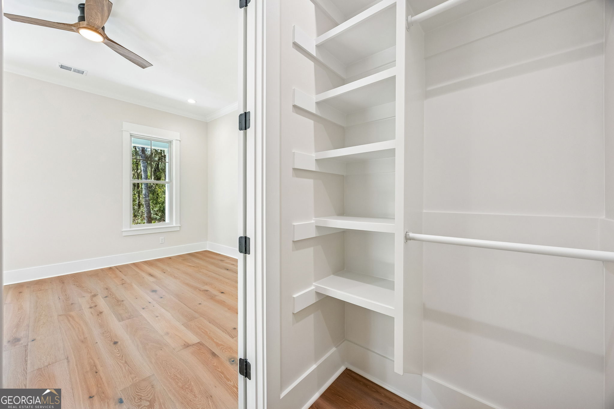 308 Anchor Way St. Marys, GA 31558 - Photo 36 of 55 a view of an empty room with a window and wooden floor