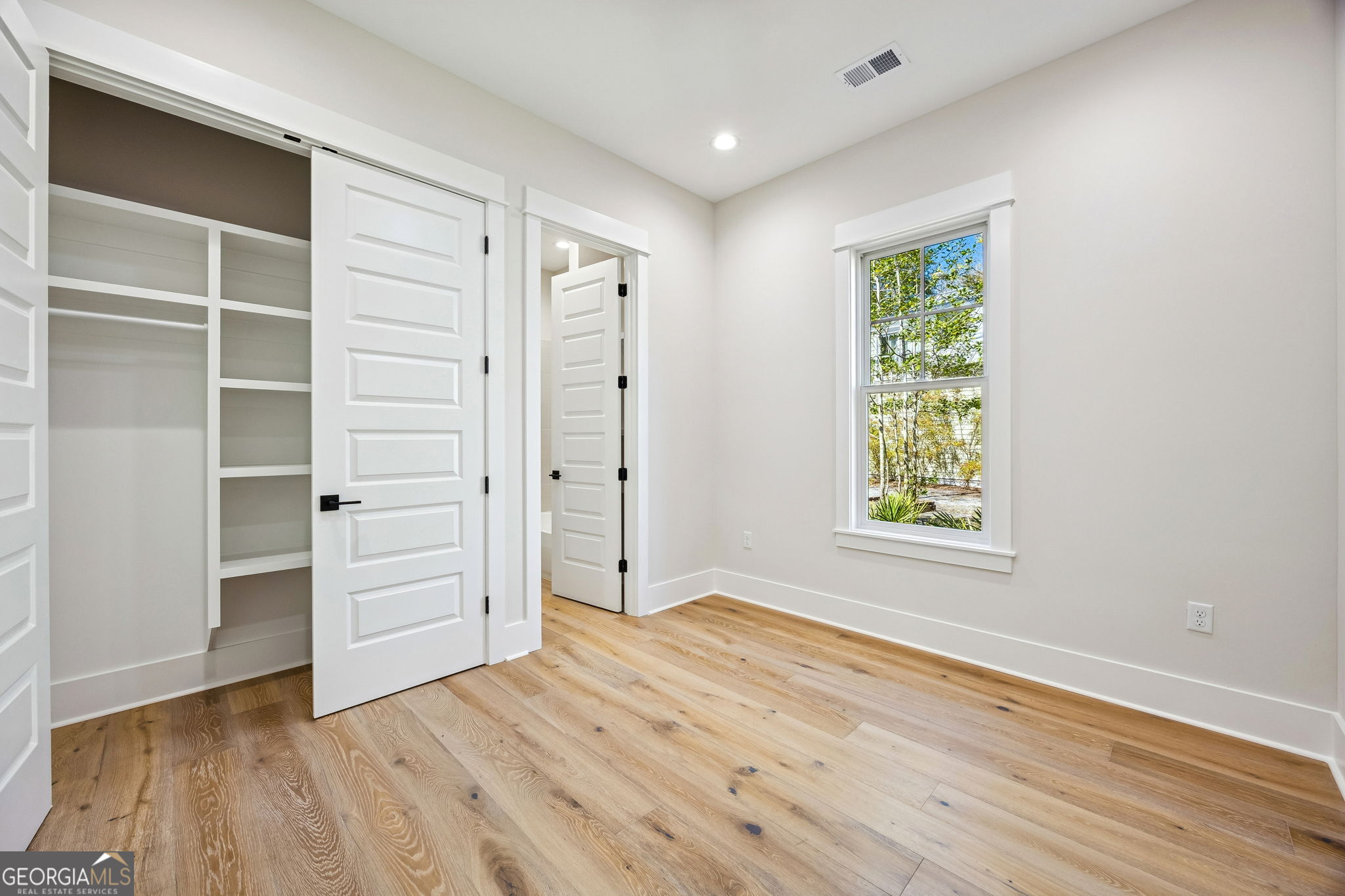 308 Anchor Way St. Marys, GA 31558 - Photo 42 of 55 an empty room with wooden floor closet and windows