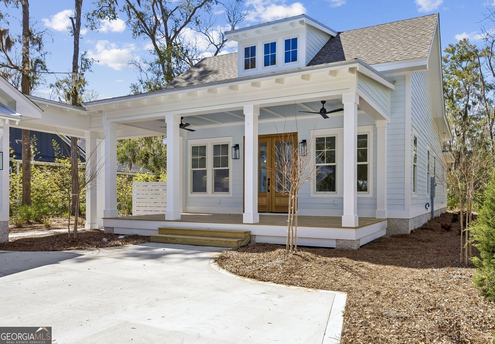 308 Anchor Way St. Marys, GA 31558 - Photo 8 of 55 a view of a brick house with small yard plants and large tree