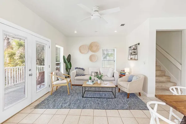 a living room with furniture and wooden floor