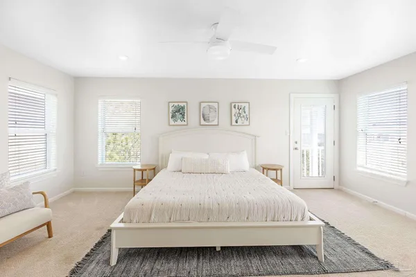 a bedroom with a large bed and a flat screen tv