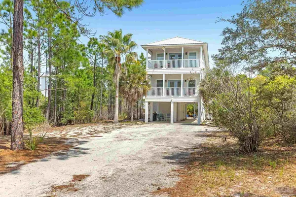 a front view of a building with a yard