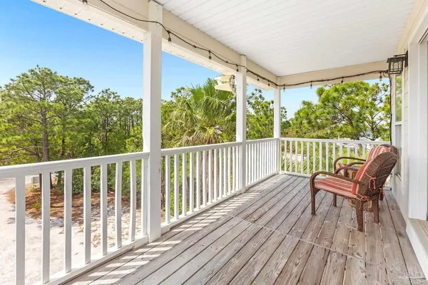 a view of a house with backyard and wooden fence