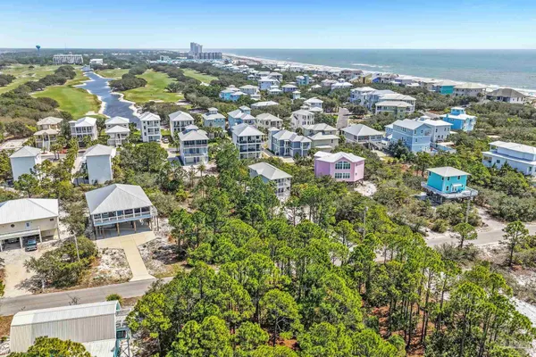 an aerial view of residential houses with city view