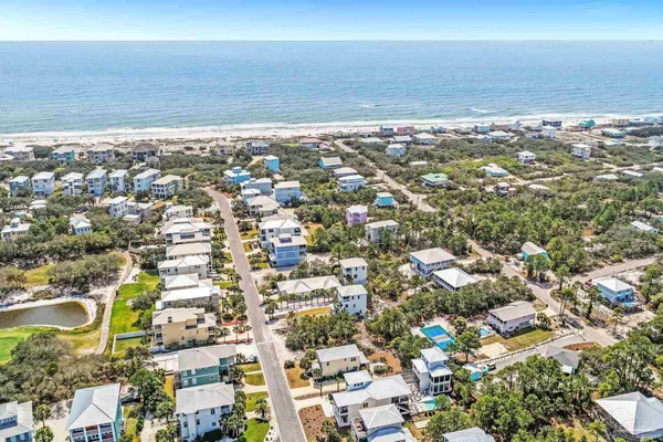 an aerial view of residential houses with outdoor space