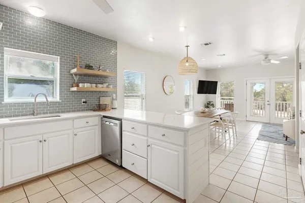 a open kitchen with white cabinets appliances and a sink