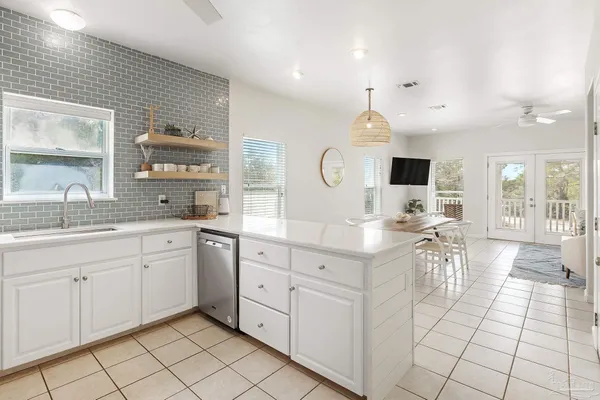 a large kitchen with kitchen island granite countertop a sink and a stove top oven