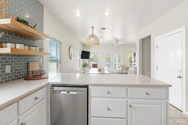 a kitchen with stainless steel appliances granite countertop a refrigerator sink and stove