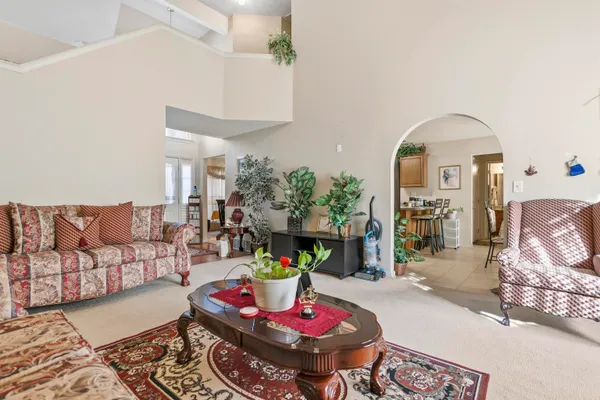 a living room with furniture and a chandelier