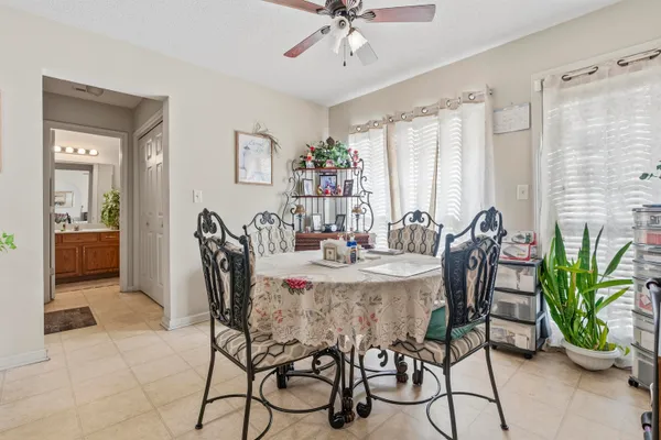 a view of a dining room with furniture and a potted plant