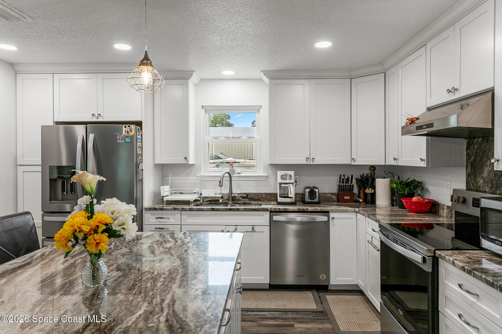 4310 Sand Point Road Grant Valkaria, FL 32949 - Photo 12 of 50 a kitchen with a sink appliances and cabinets