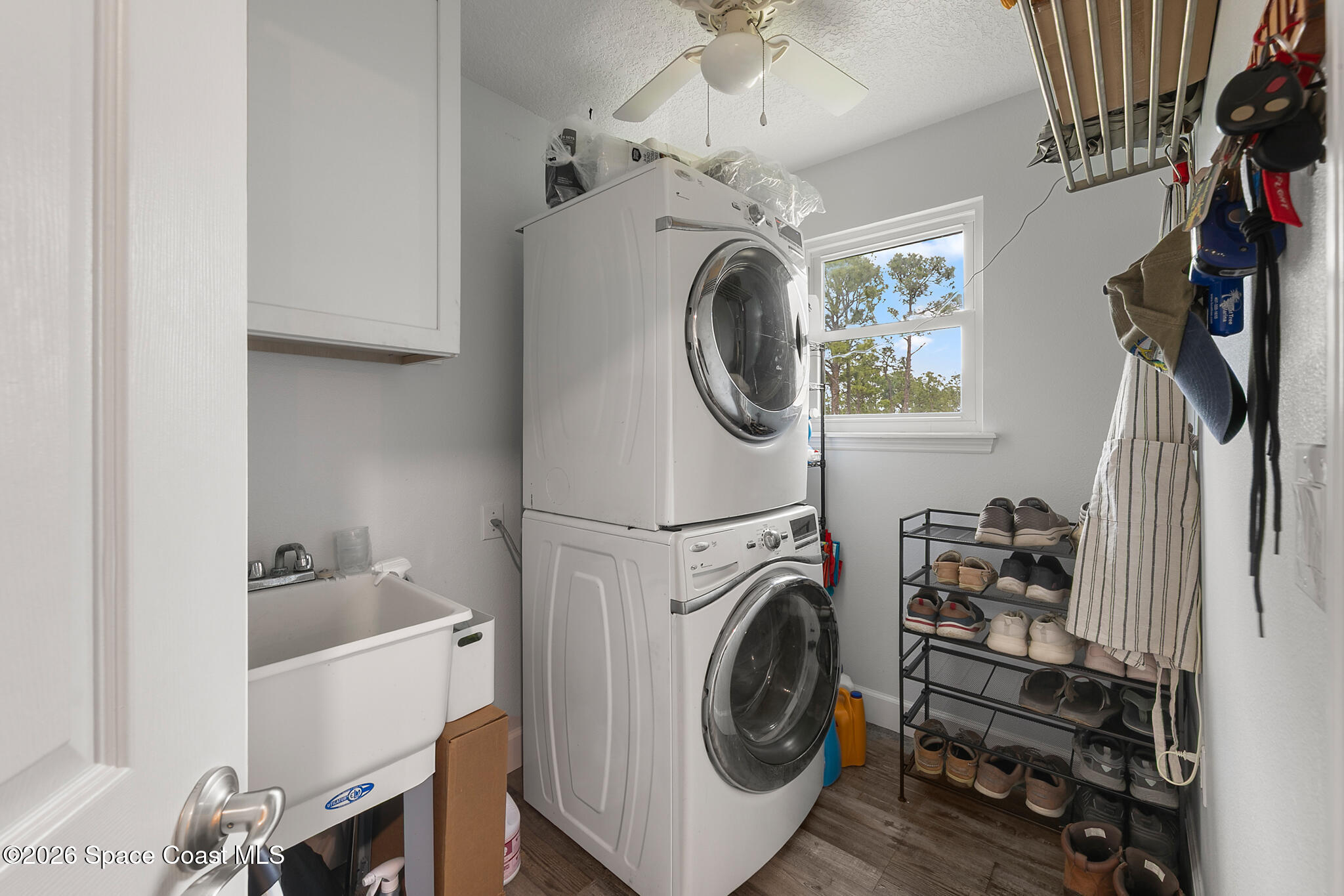 4310 Sand Point Road Grant Valkaria, FL 32949 - Photo 15 of 50 a view of a storage and utility room with washer and dryer