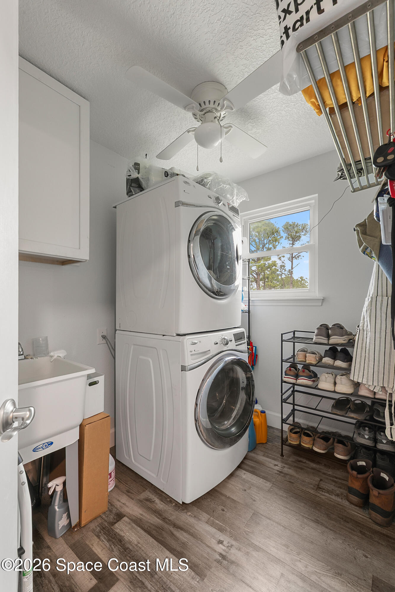 4310 Sand Point Road Grant Valkaria, FL 32949 - Photo 16 of 50 a view of a storage and utility room with washer and dryer