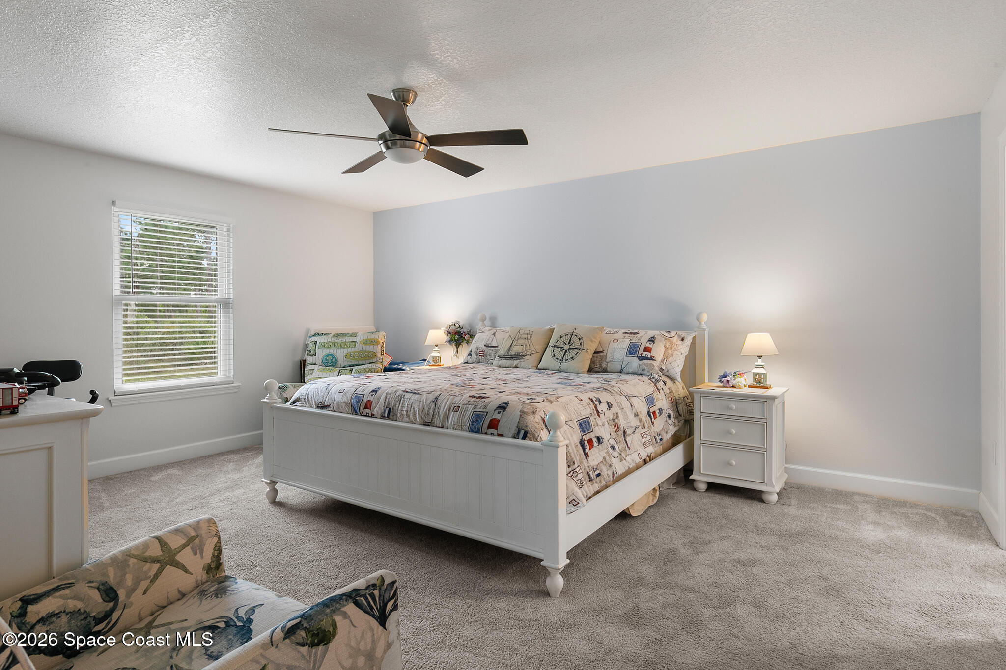 4310 Sand Point Road Grant Valkaria, FL 32949 - Photo 17 of 50 a bedroom with a bed and a window