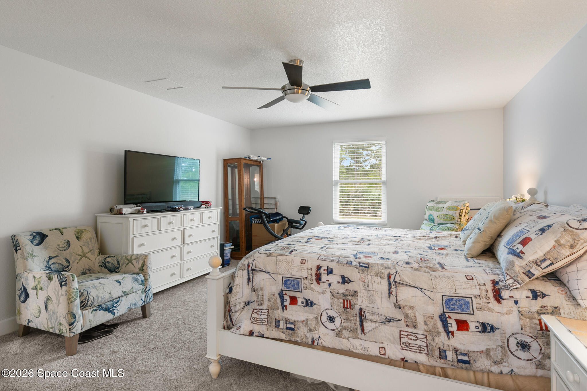 4310 Sand Point Road Grant Valkaria, FL 32949 - Photo 19 of 50 a bedroom with a bed and flat screen tv