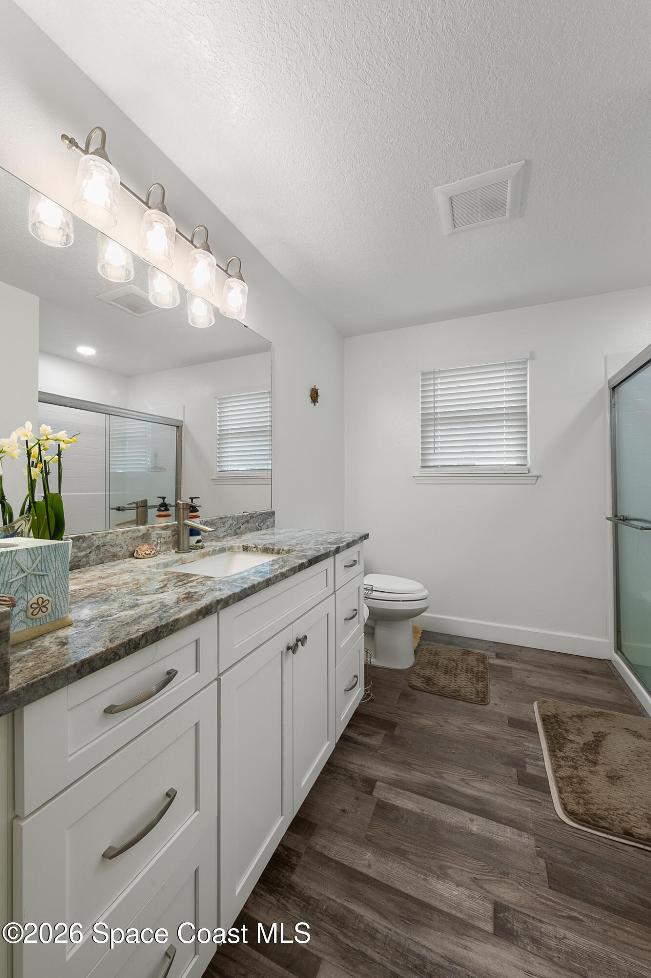 4310 Sand Point Road Grant Valkaria, FL 32949 - Photo 21 of 50 a bathroom with a granite countertop sink and a mirror