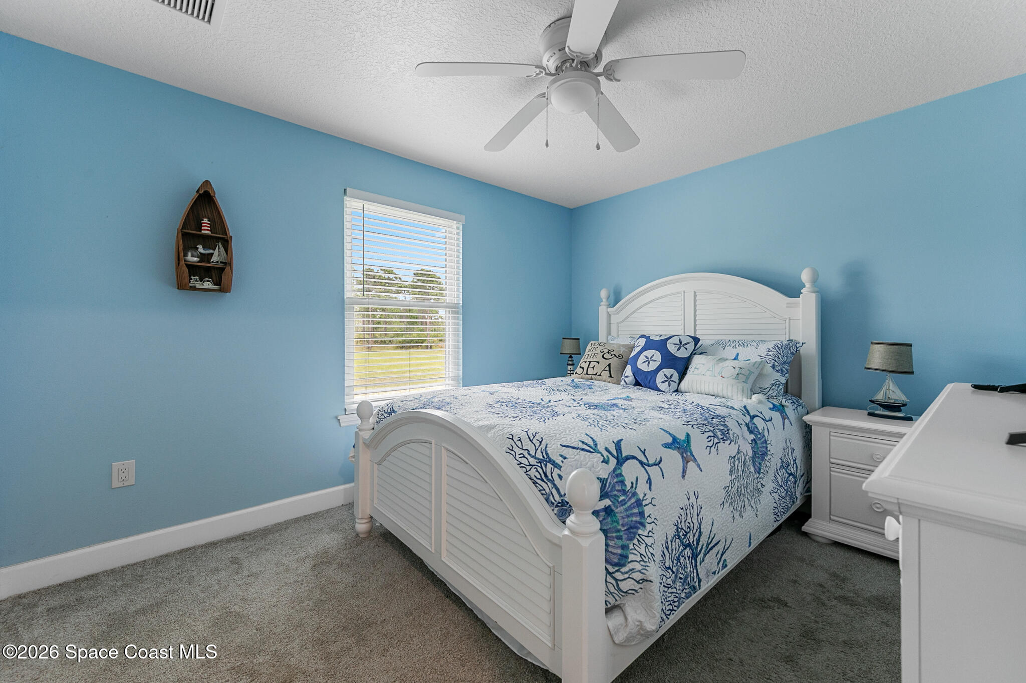 4310 Sand Point Road Grant Valkaria, FL 32949 - Photo 23 of 50 a bedroom with a bed and a window