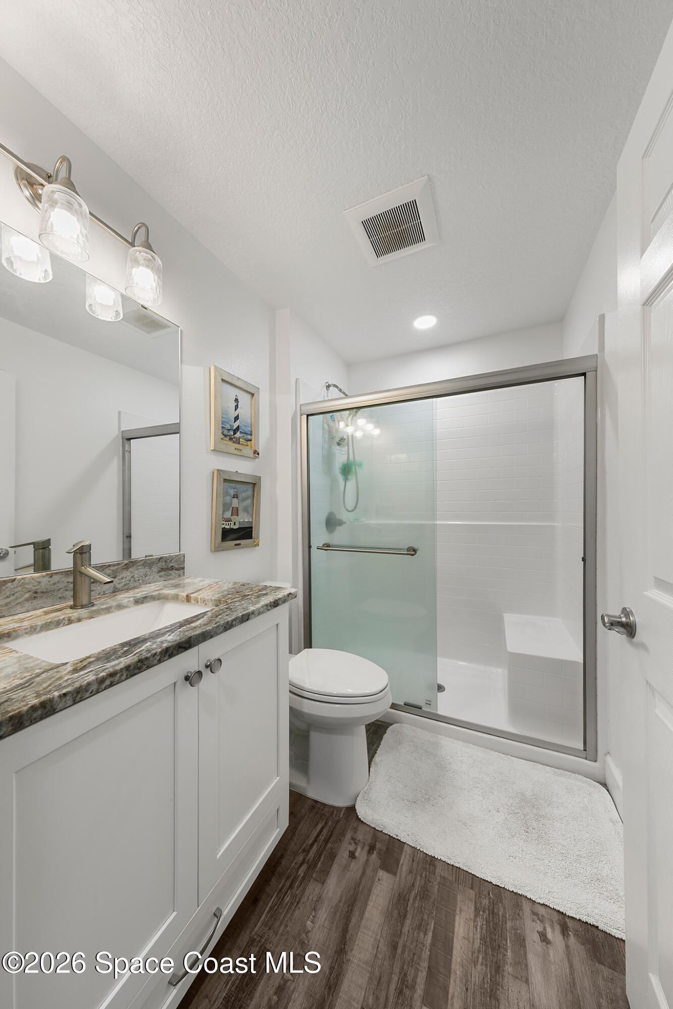4310 Sand Point Road Grant Valkaria, FL 32949 - Photo 25 of 50 a bathroom with a granite countertop sink toilet and shower