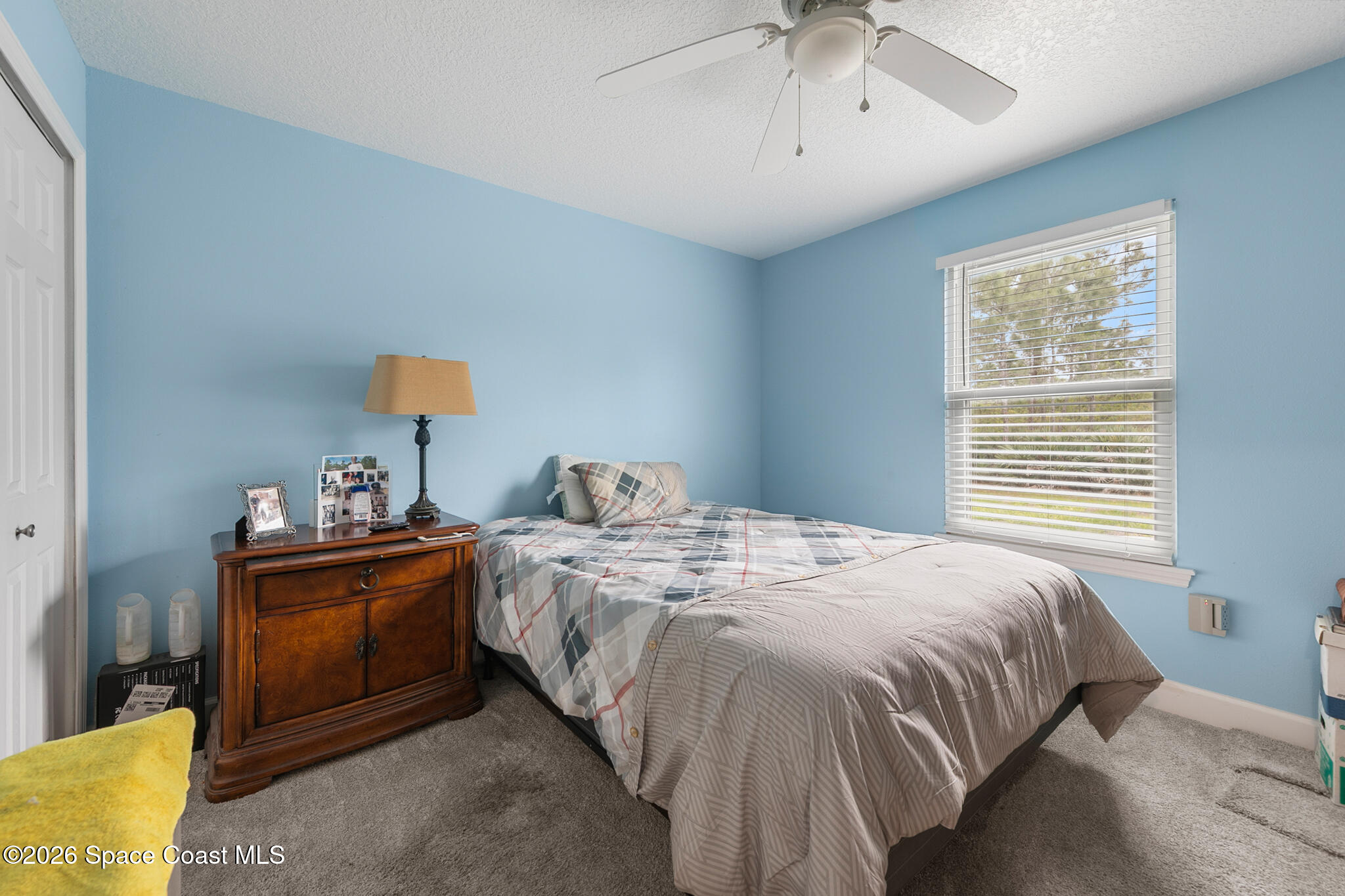 4310 Sand Point Road Grant Valkaria, FL 32949 - Photo 27 of 50 a bedroom with a bed and a chandelier