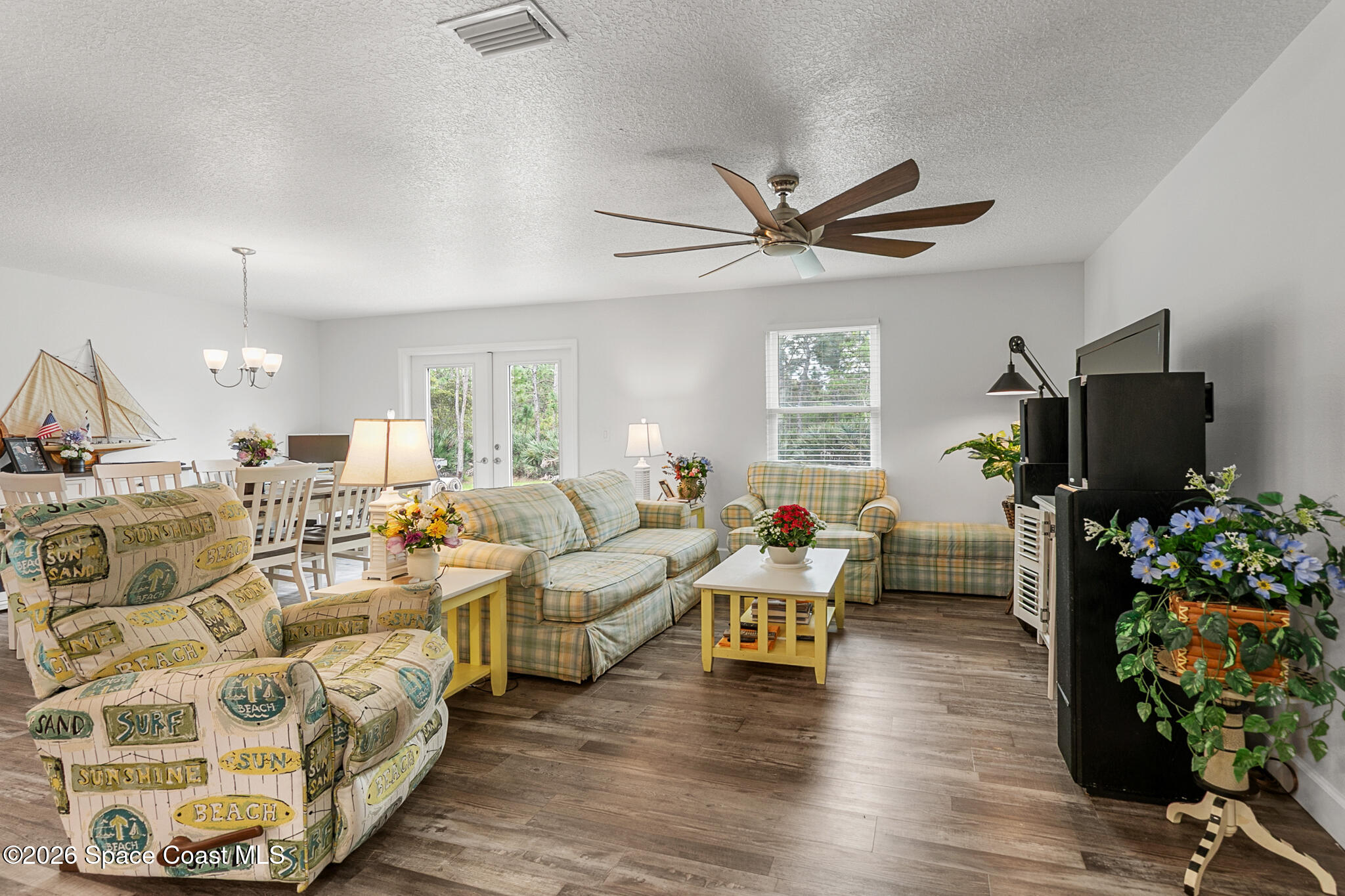 4310 Sand Point Road Grant Valkaria, FL 32949 - Photo 3 of 50 a living room with furniture and a flat screen tv
