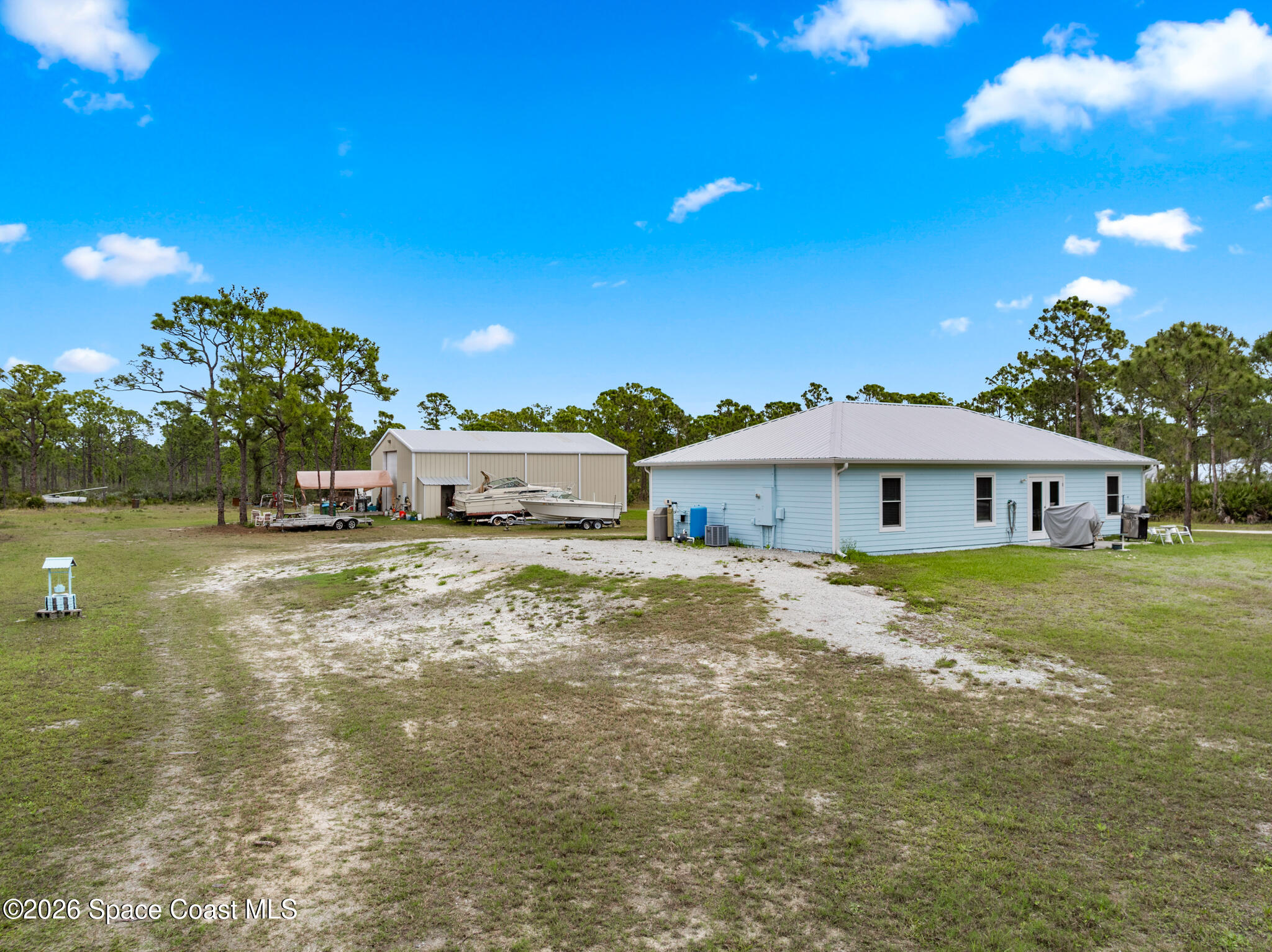 4310 Sand Point Road Grant Valkaria, FL 32949 - Photo 31 of 50 a view of a house with a yard