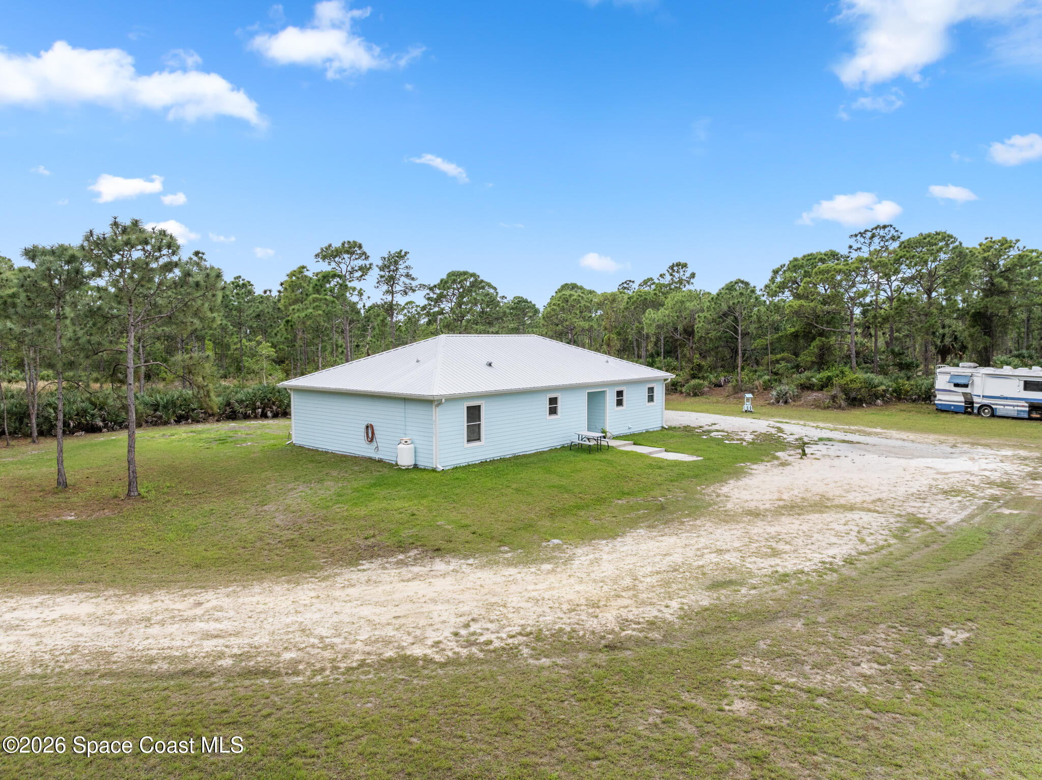 4310 Sand Point Road Grant Valkaria, FL 32949 - Photo 32 of 50 a view of a house with a yard and a lake view