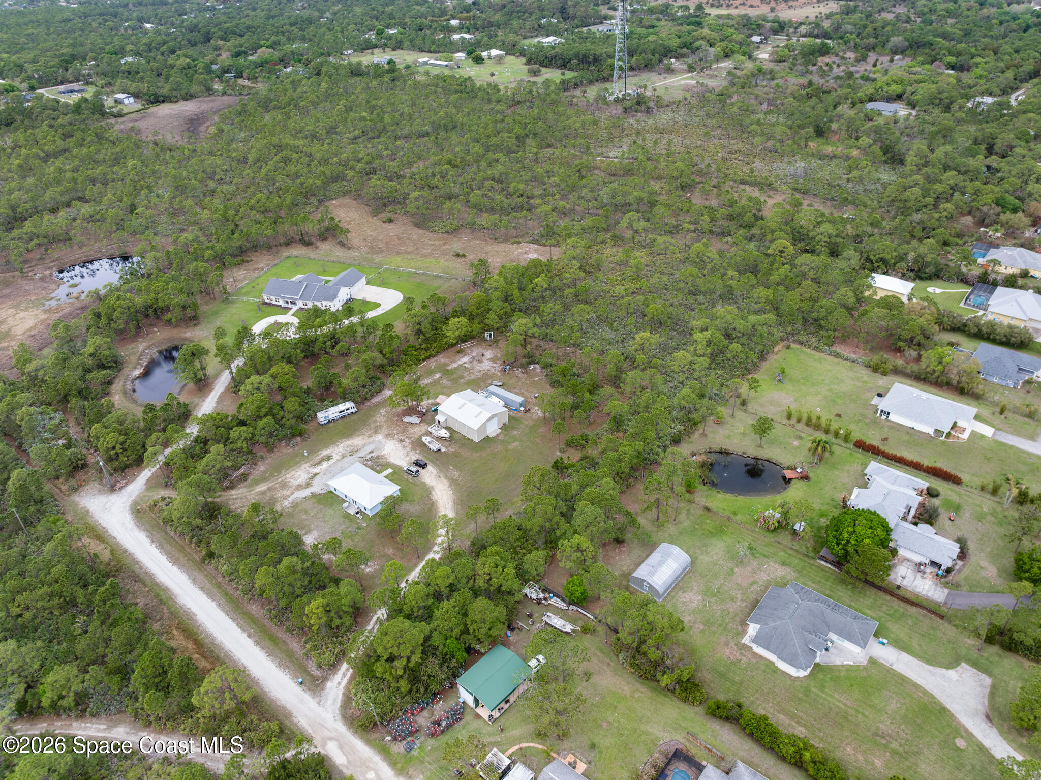 4310 Sand Point Road Grant Valkaria, FL 32949 - Photo 37 of 50 an aerial view of residential houses with outdoor space and trees