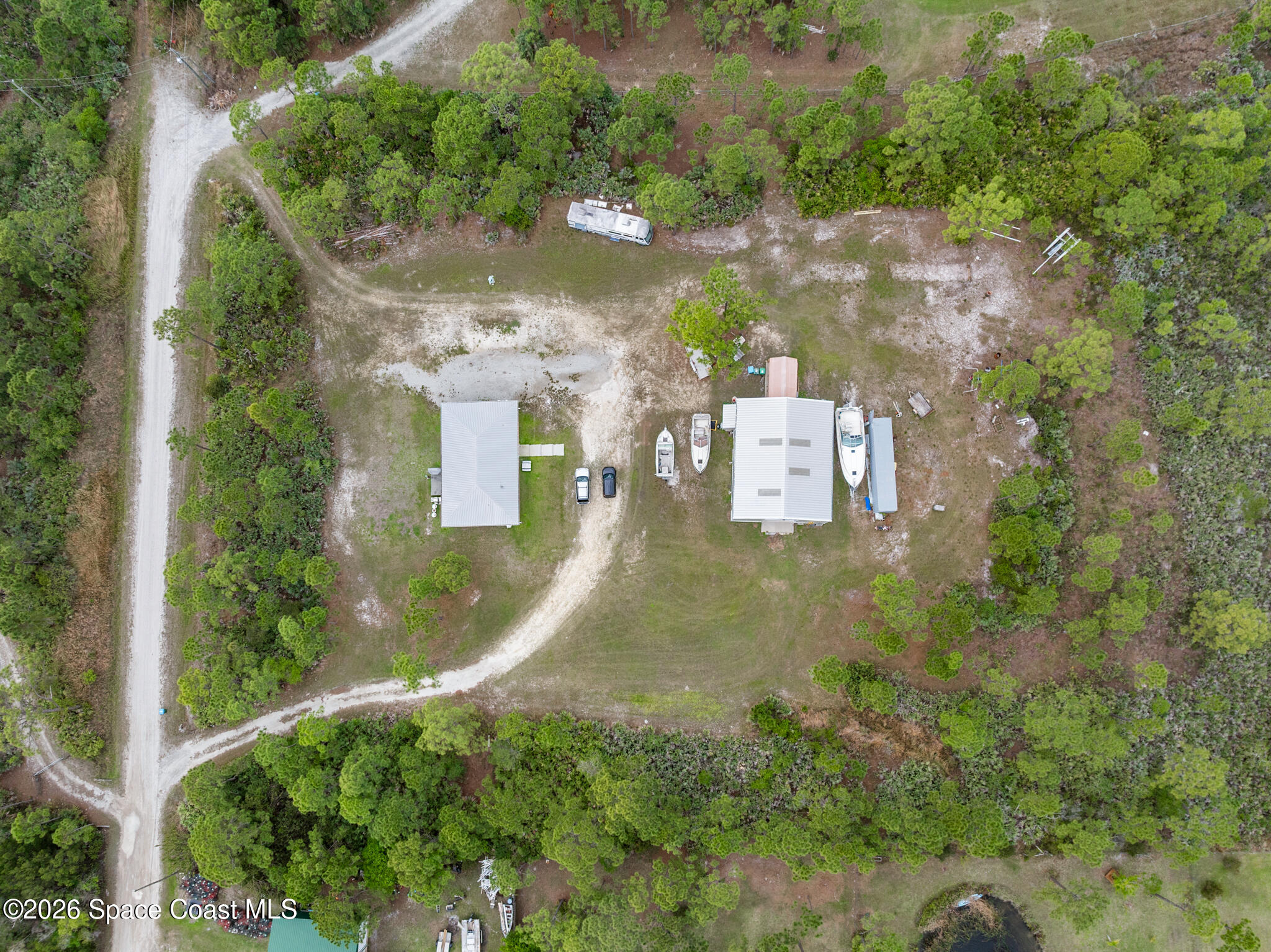 4310 Sand Point Road Grant Valkaria, FL 32949 - Photo 38 of 50 an aerial view of residential house with outdoor space