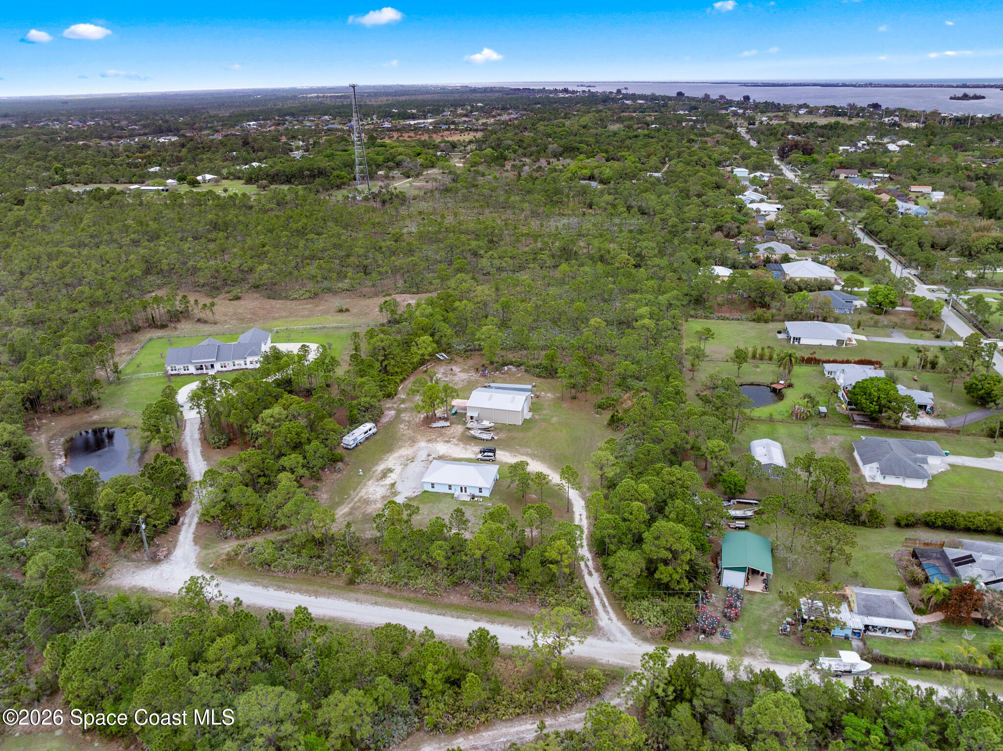 4310 Sand Point Road Grant Valkaria, FL 32949 - Photo 40 of 50 an aerial view of residential houses with outdoor space and trees