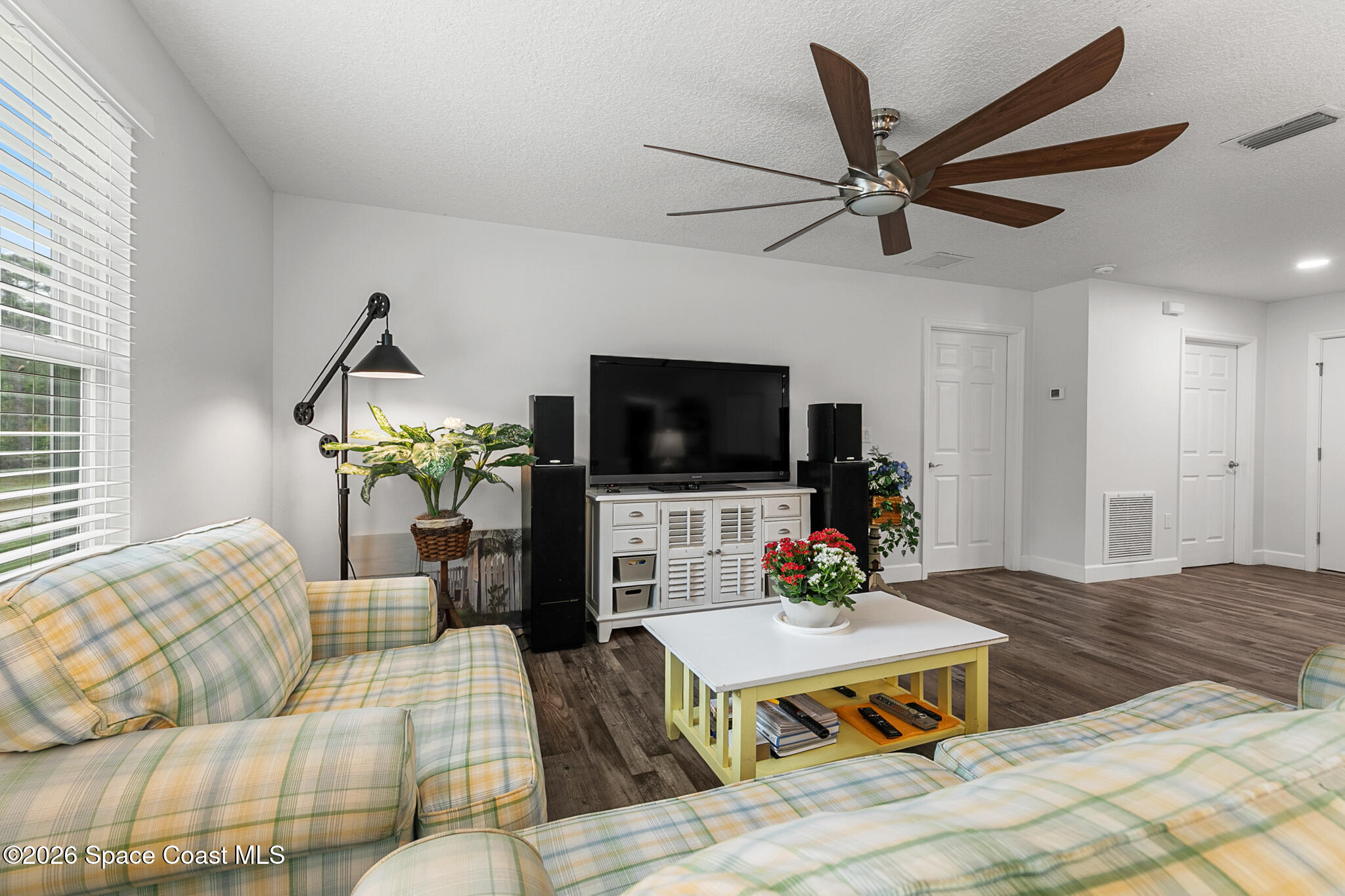 4310 Sand Point Road Grant Valkaria, FL 32949 - Photo 4 of 50 a living room with furniture and a flat screen tv