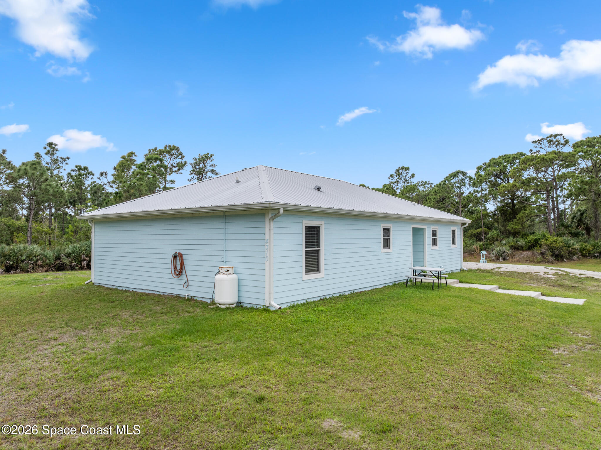 4310 Sand Point Road Grant Valkaria, FL 32949 - Photo 48 of 50 a house with a yard
