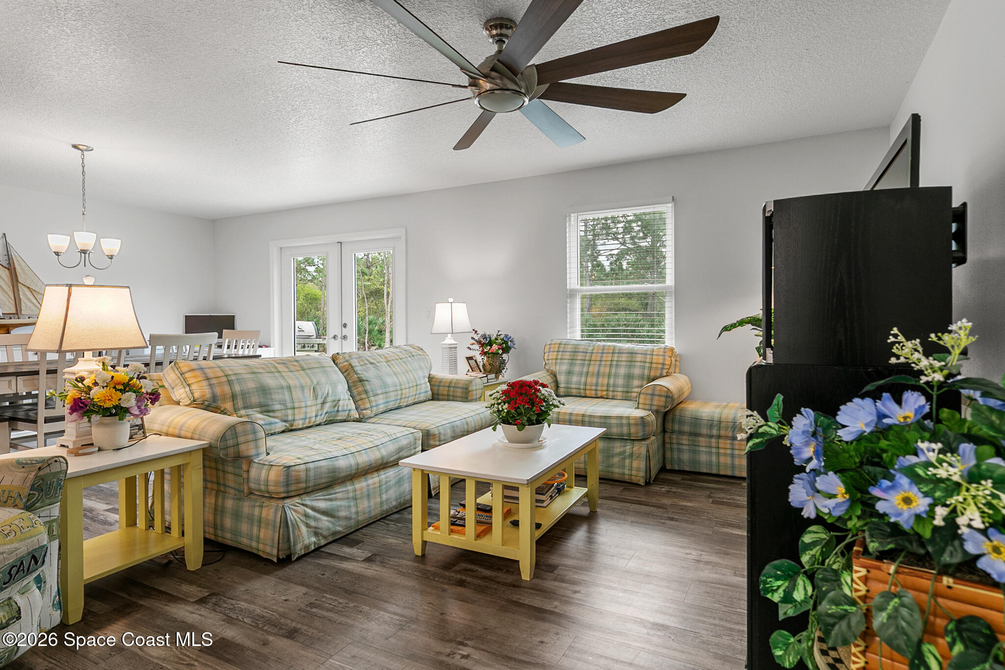 4310 Sand Point Road Grant Valkaria, FL 32949 - Photo 6 of 50 a living room with furniture potted plant and a flat screen tv