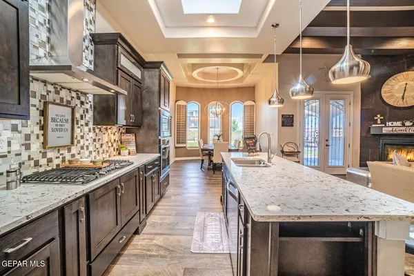a large kitchen with stainless steel appliances granite countertop a large stove a sink dishwasher and dishwasher with a dining table