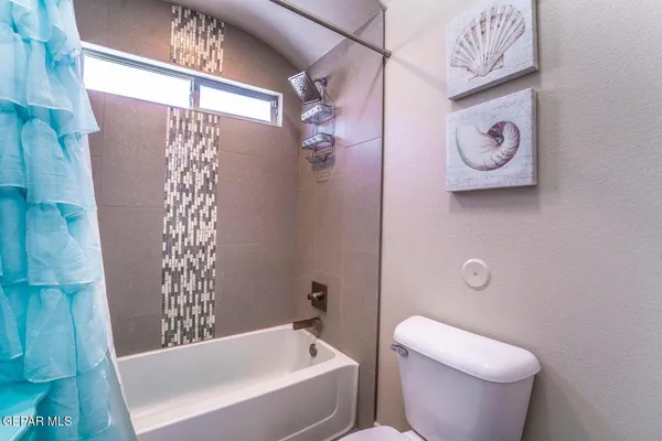 a bathroom with a toilet and a bathtub