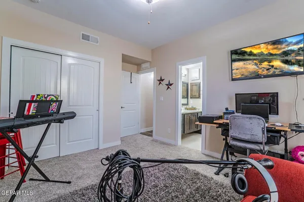 a livingroom with workspace and a window