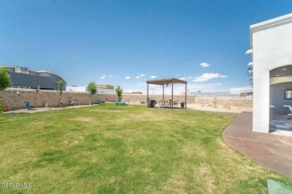 a swimming pool with outdoor seating and yard