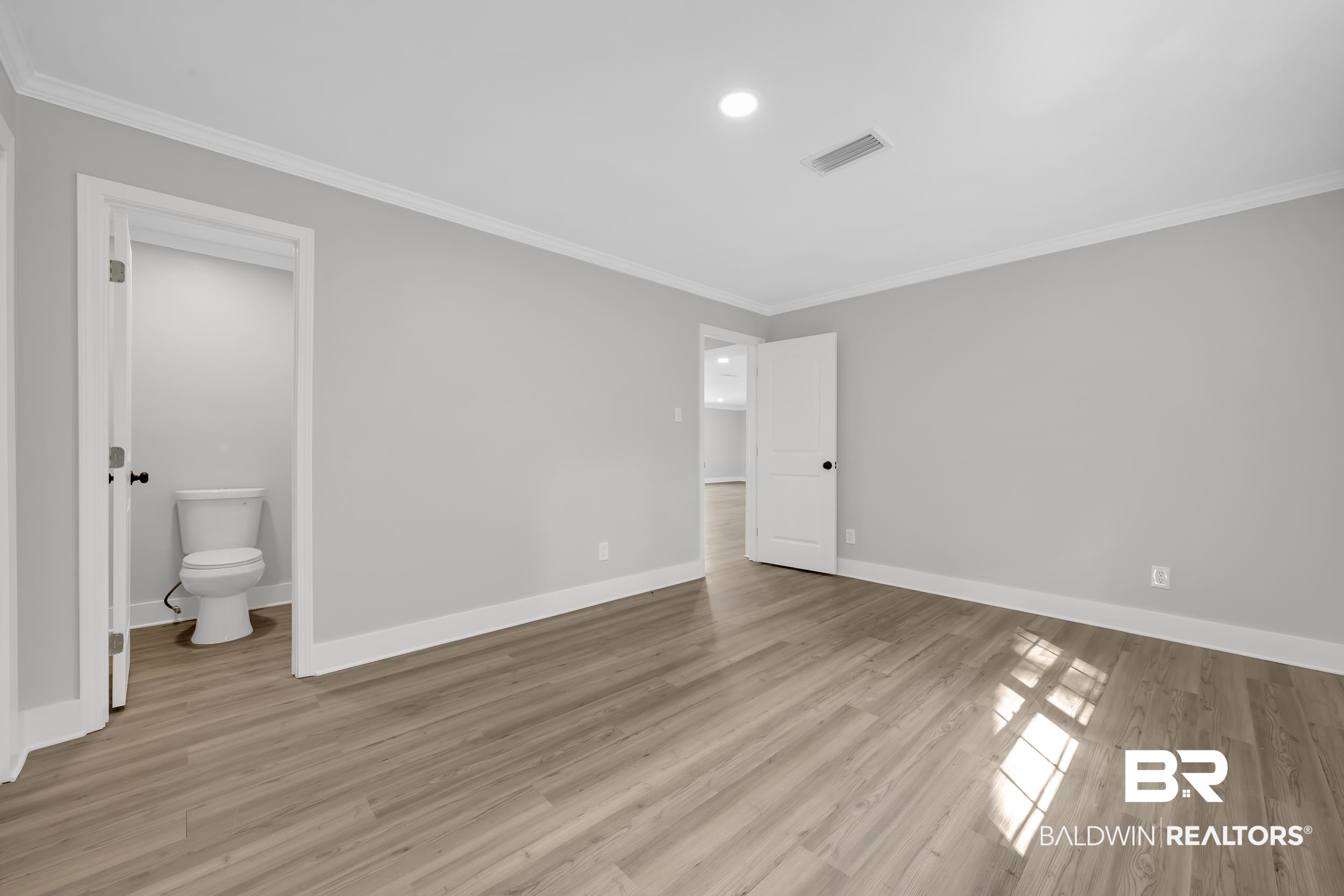 8351 Theodore Dawes Road Theodore, AL 36582 - Photo 15 of 46 Unfurnished bedroom with crown molding, light wood-type flooring, and recessed lighting